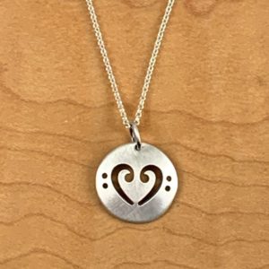 A necklace with a pendant featuring a bass clef.