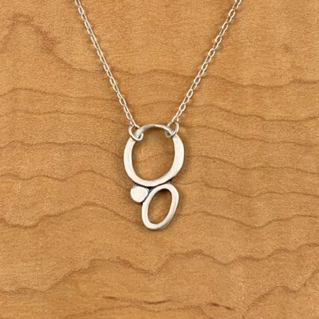 A sterling silver necklace featuring a sandpiper motif.