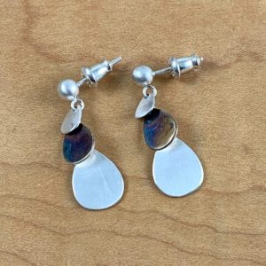 A pair of 3-Tier Cascade earrings with a blue and purple stone.